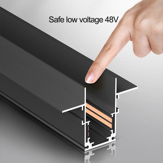 Hand pointing to a black metal strip with 'Safe low voltage 48V' text on a gray background